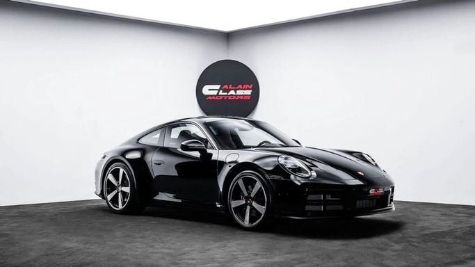 Новый Porsche 911 Carrera VIII (992) Рестайлинг, 3.0 л, 2025 в Дубае от Al Ain Class Motors Черный цвет. GCC | AUTO.AE