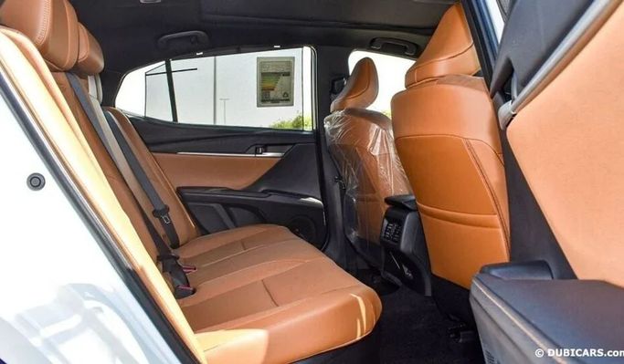 New Toyota Camry IX (XV80), 2.5 l, 2024 in Dubai by Najem Motors, White color. GCC Specs | AUTO.AE