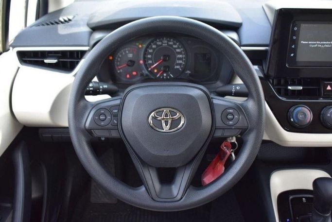 New Toyota Corolla Sporty XII (E210), 2.0 l, 2023 in Dubai by Mohamed Hakim Motors, White color. GCC Specs | AUTO.AE