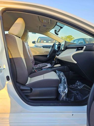 New Toyota Corolla XII (E210), 1.6 l, 2025 in Dubai by SK Motors, White color. GCC Specs | AUTO.AE