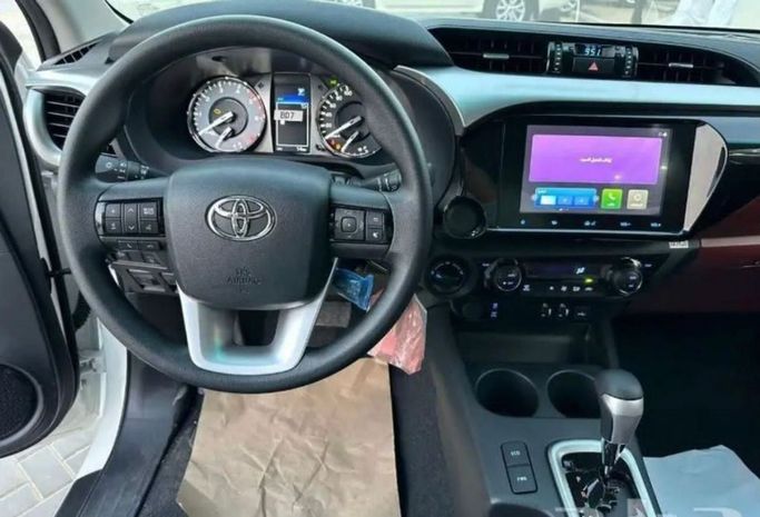 New Toyota Hilux VIII Facelift 2, 2.4 l, 2024 in Dubai by Mohamed Hakim Motors, White color. GCC Specs | AUTO.AE