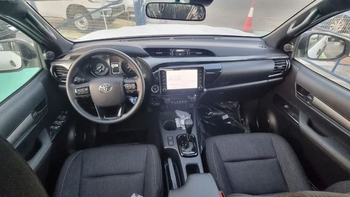New Toyota Hilux VIII Facelift, 2.8 l, 2023 in Dubai by Mohamed Hakim Motors, White color. GCC Specs | AUTO.AE