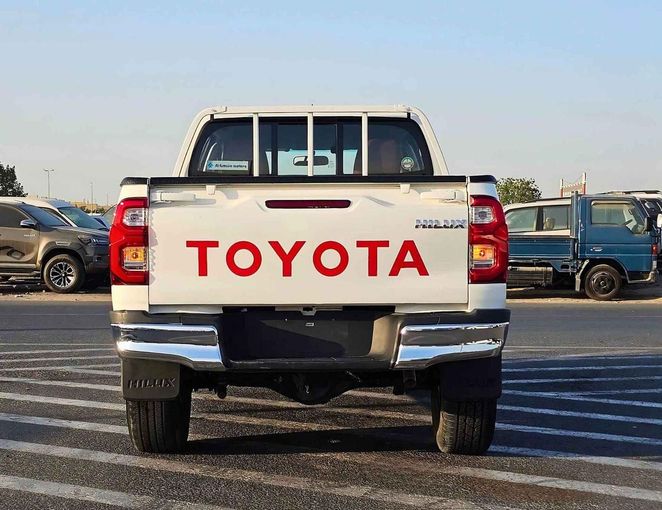New Toyota Hilux VIII Facelift, 2.7 l, 2023 in Dubai by SK Motors, White color. GCC Specs | AUTO.AE