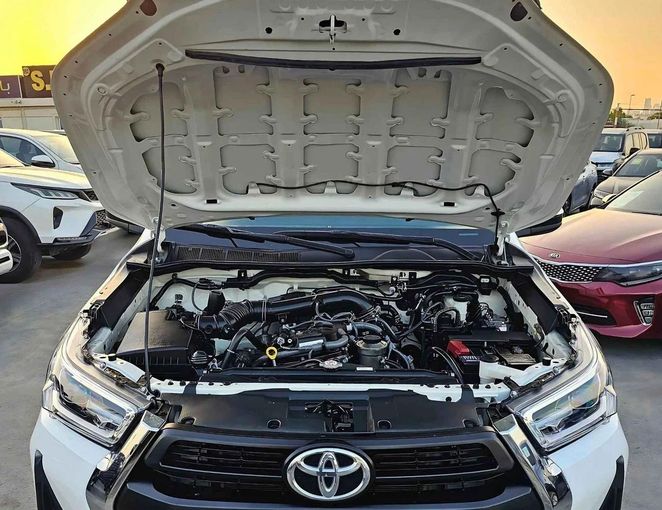 New Toyota Hilux VIII Facelift, 2.7 l, 2023 in Dubai by SK Motors, White color. GCC Specs | AUTO.AE
