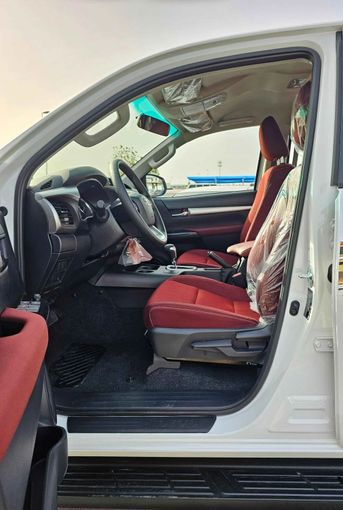 New Toyota Hilux VIII Facelift 2, 2.7 l, 2024 in Dubai by SK Motors, White color. GCC Specs | AUTO.AE