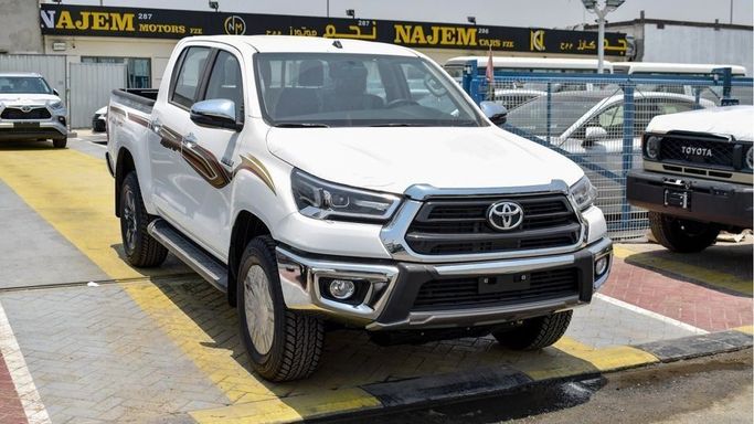 New Toyota Hilux VIII Facelift, 4.0 l, 2024 in Dubai by Najem Motors, White color. GCC Specs | AUTO.AE