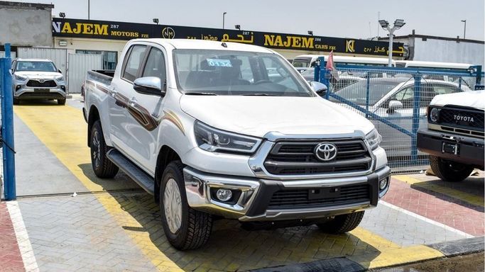New Toyota Hilux VIII Facelift, 2.7 l, 2024 in Dubai by Najem Motors, White color. GCC Specs | AUTO.AE