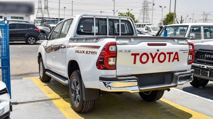 New Toyota Hilux VIII Facelift, 2.7 l, 2024 in Dubai by Najem Motors, White color. GCC Specs | AUTO.AE