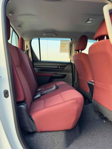 New Toyota Hilux VIII Facelift, 2.4 l, 2025 in Dubai by SK Motors, White color. GCC Specs | AUTO.AE