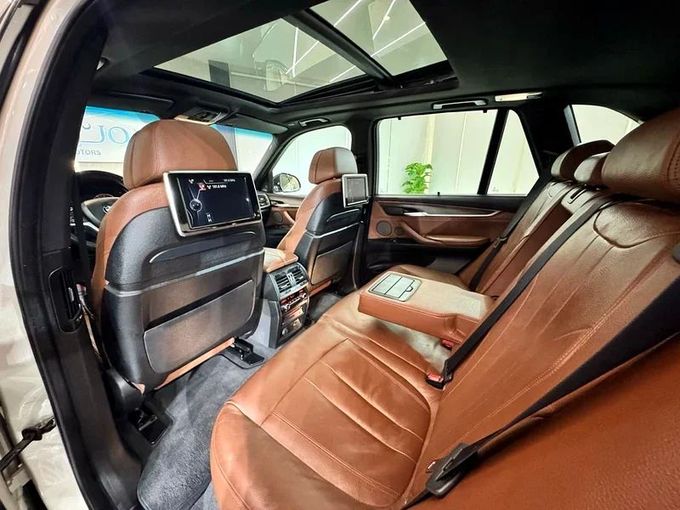 Used BMW X5 50i III (F15), 4.4 l, 2017 in Sharjah by Ayoon Alhoot Motors, Golden color. GCC Specs | AUTO.AE