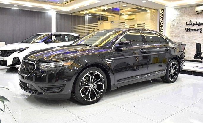 Подержанный Ford Taurus VI Рестайлинг, 3.5 л, 2014 в Шардже от Honey Gidosha Used Cars Tr. Черный цвет.  | AUTO.AE