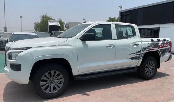 New Mitsubishi L200 VI, 2.4 l, 2023 in Sharjah by Nour Alnukhba Motors, White color. GCC Specs | AUTO.AE