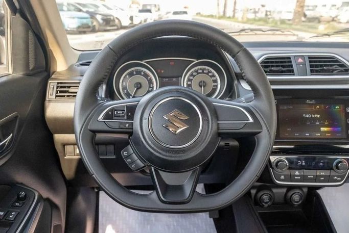 Новый Suzuki DZire III Рестайлинг, 1.2 л, 2024 в Шардже от Nour Alnukhba Motors Серебристый цвет. Other | AUTO.AE