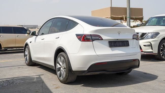 Used Tesla Model Y Performance I, 2023 in Sharjah by Alnujoom Al Malakiah Used Cars, White color. American Specs | AUTO.AE